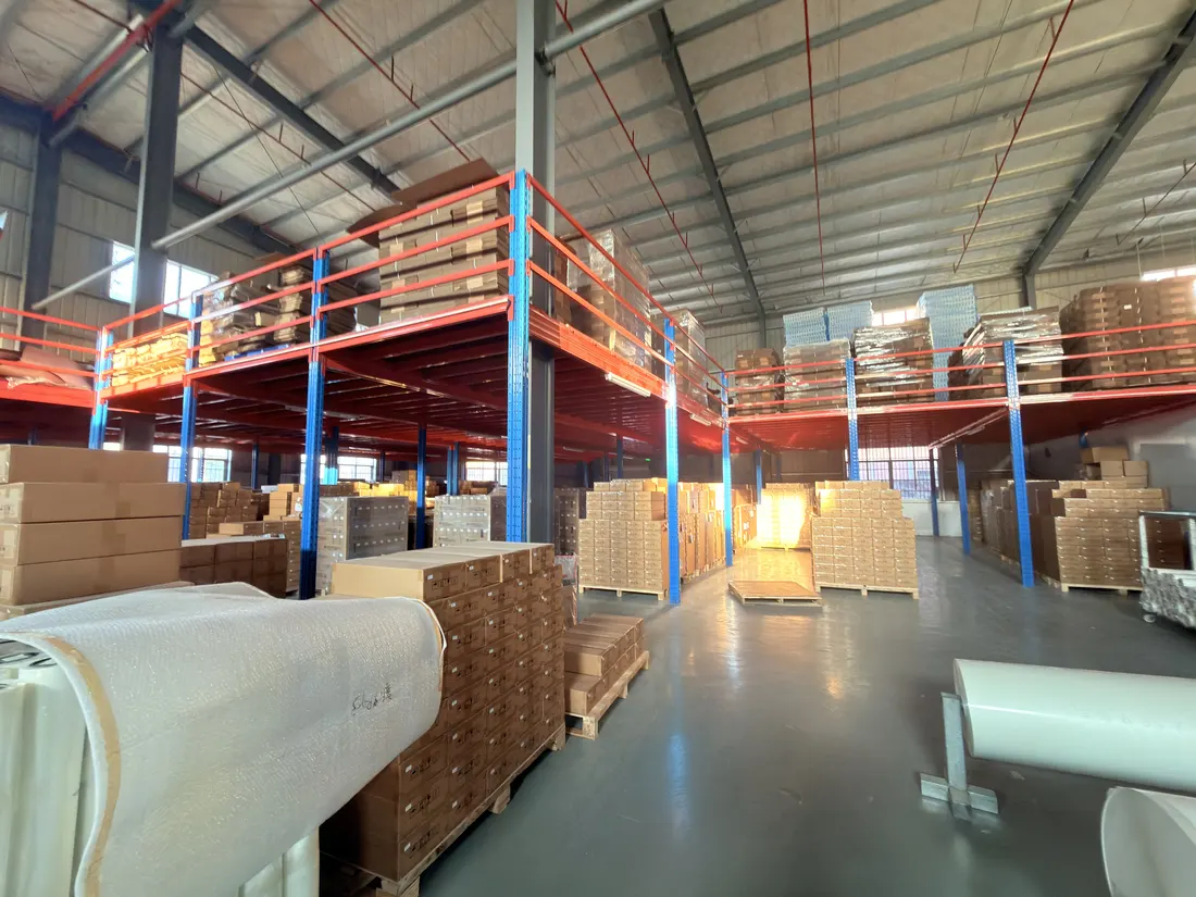 Warehouse racking with palletised boxes and film rolls in the foreground