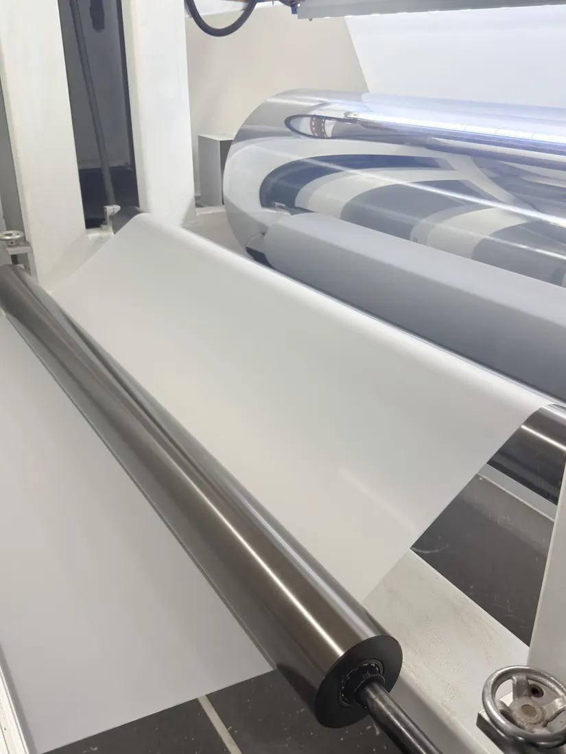 PET film web running over a large chromed roller on the coating line