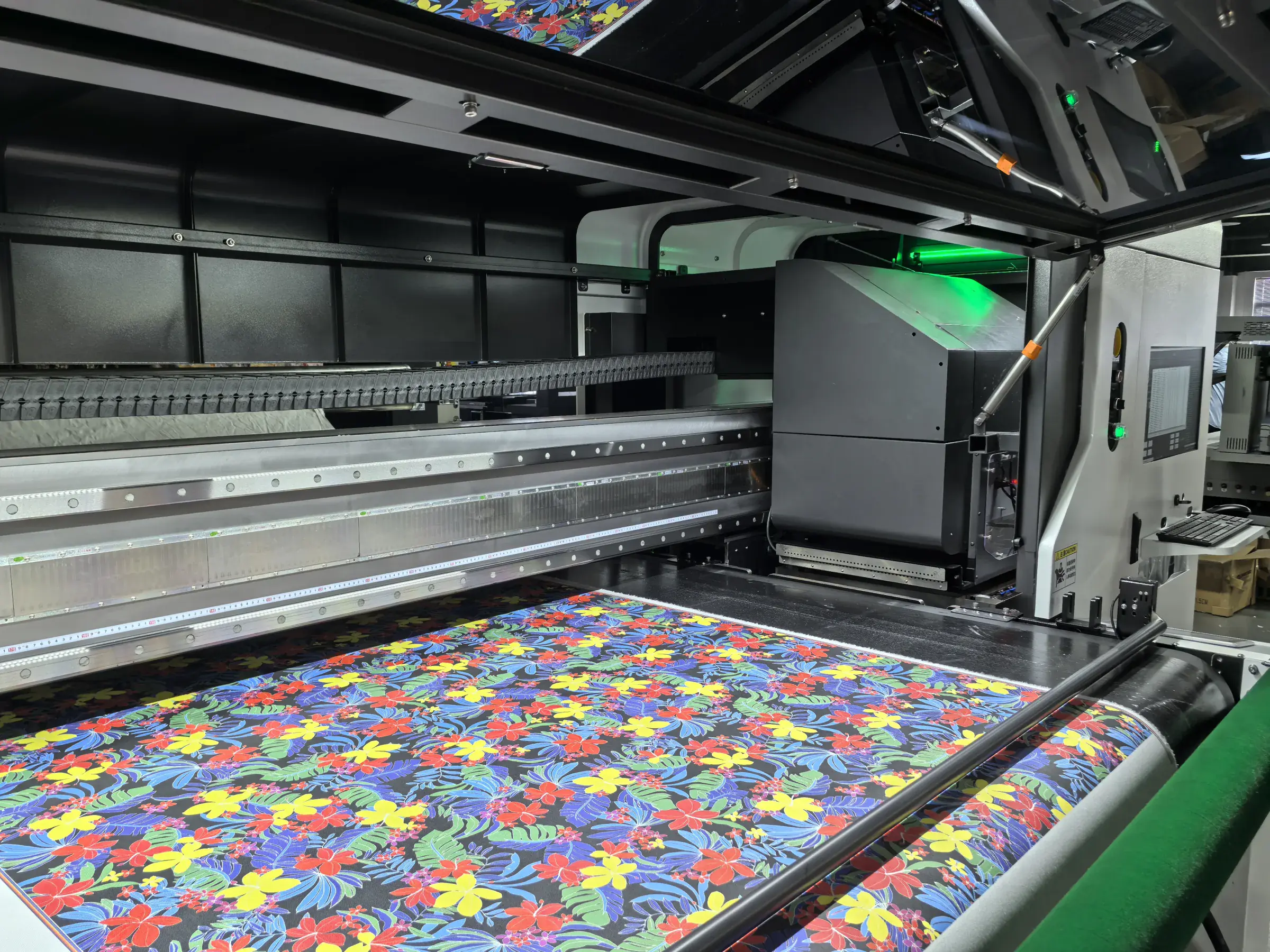 Industrial textile printer running a colourful fabric job on the factory floor