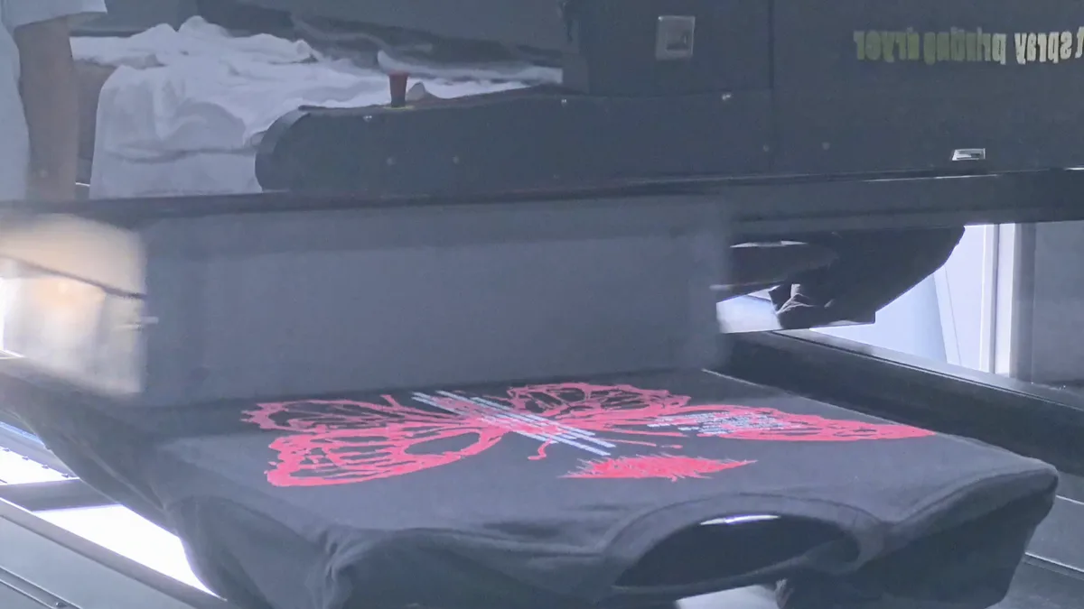 HY 2D DTG print carriage applying white and color to a dark garment